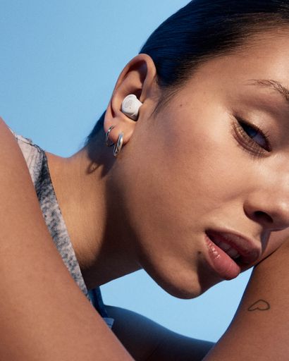 Urbanista Porto Cloud White true wireless earbud lifestyle close-up