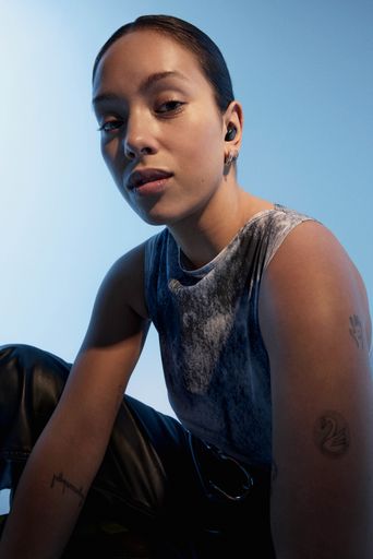 Urbanista Porto Midnight Black earbud lifestyle portrait